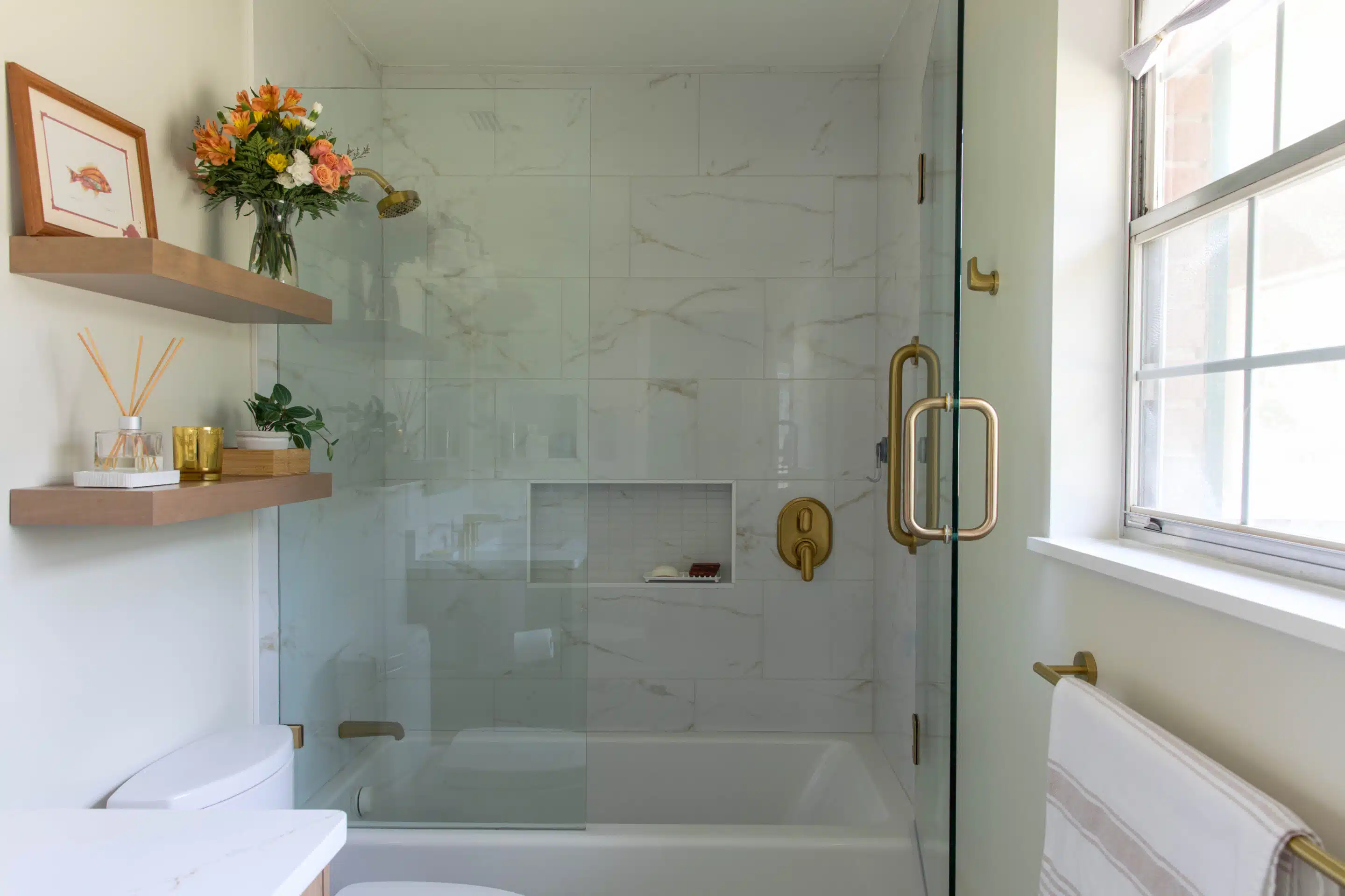 shower with gold fixtures in a bathroom designed for safety and style