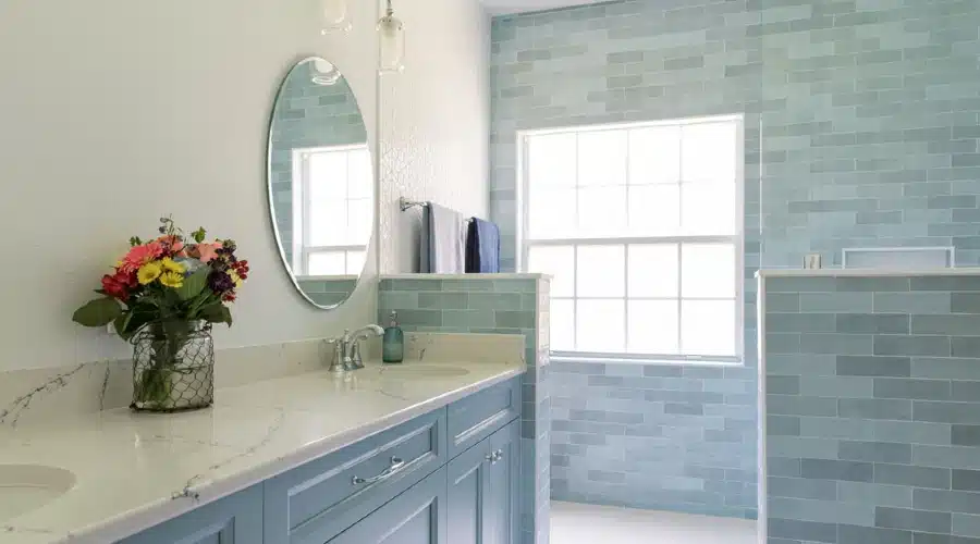 remodeling for retirement master bathroom with blue vanity, quartz top, and flowers – Hughes Bath